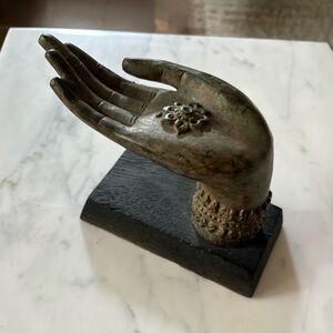 Buddha hand with chakra flower on wood base